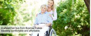 Smiling senior woman in wheelchair outside with caregiver